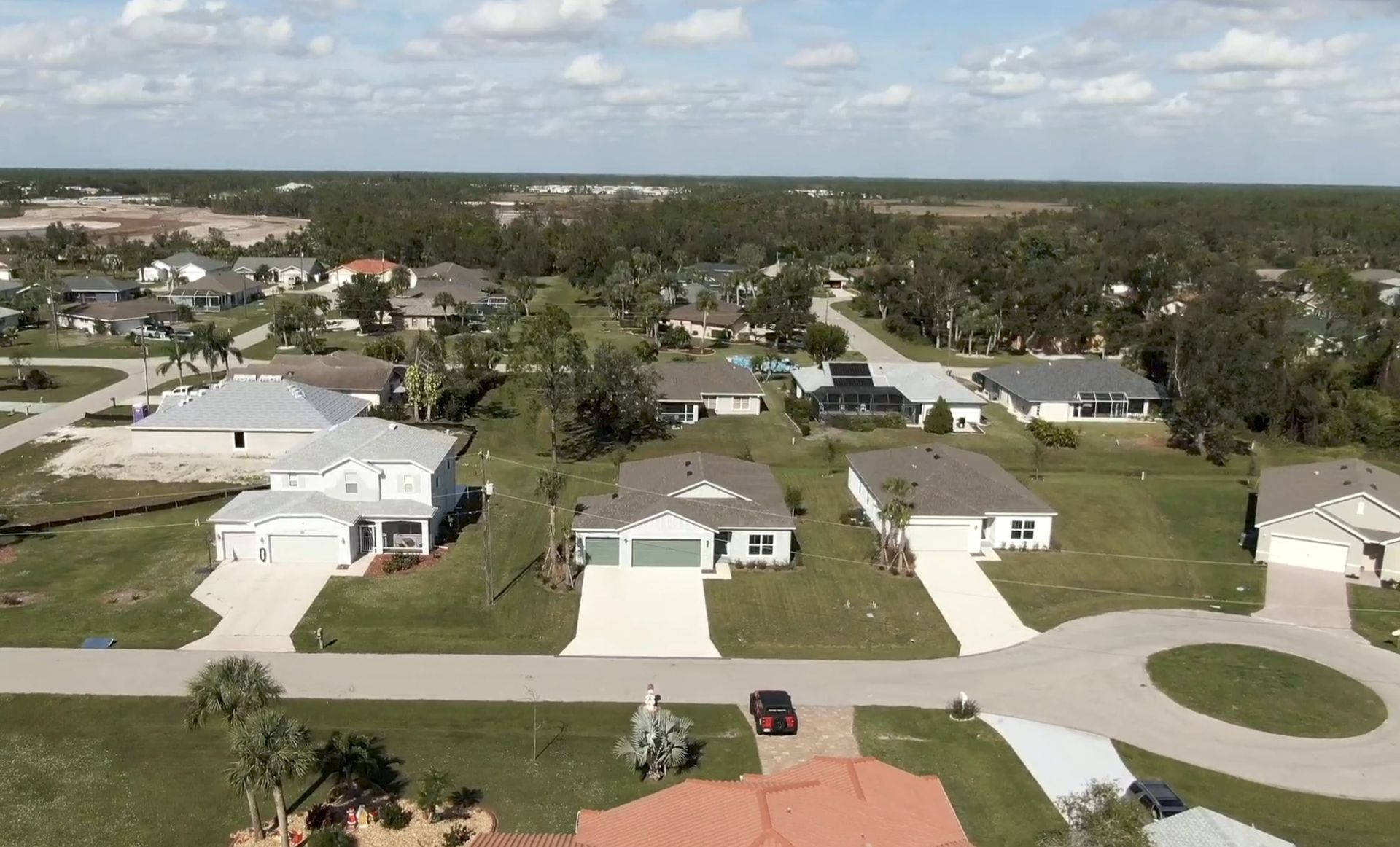 An aerial view of a residential area with houses and trees