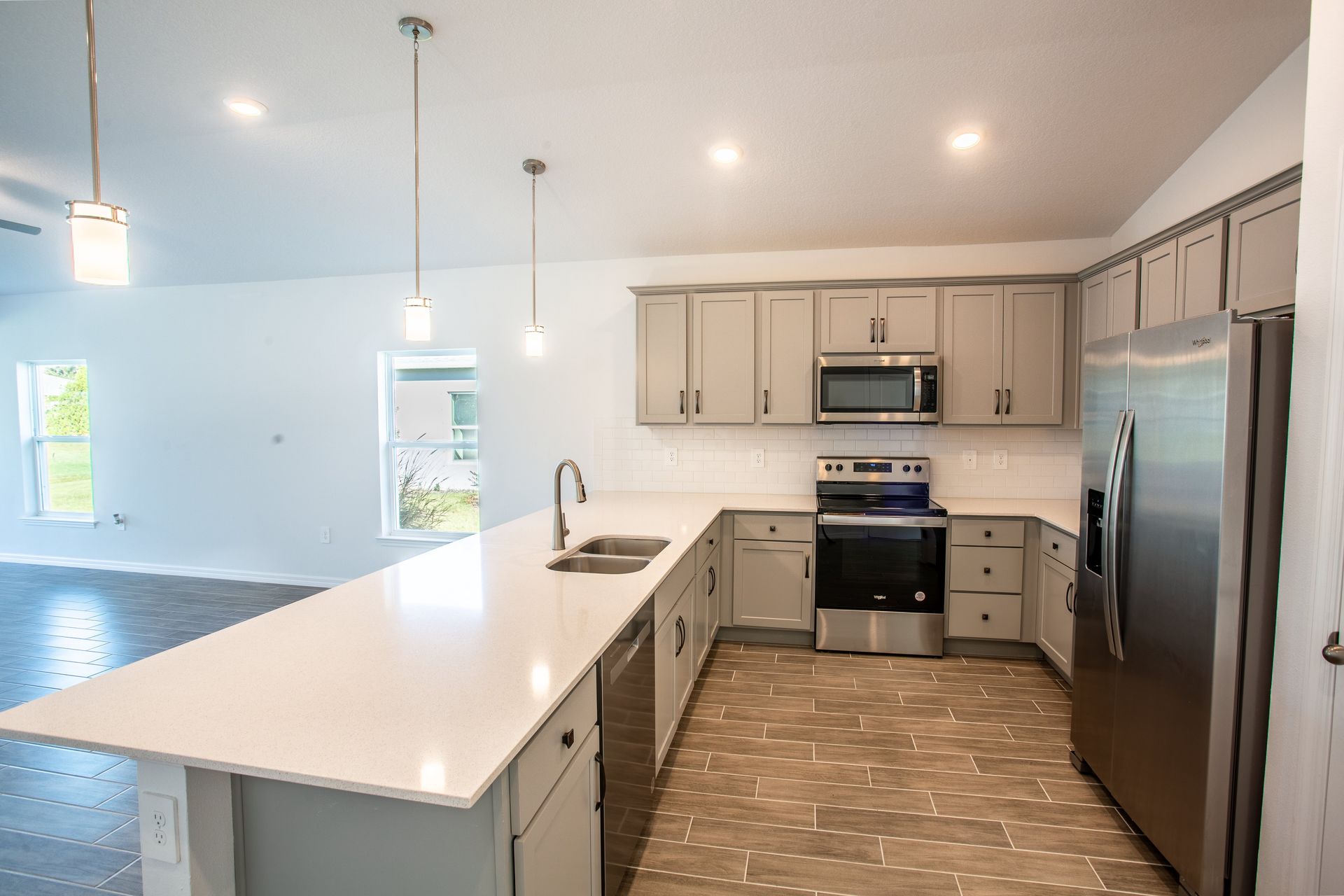 A kitchen with stainless steel appliances and white cabinets