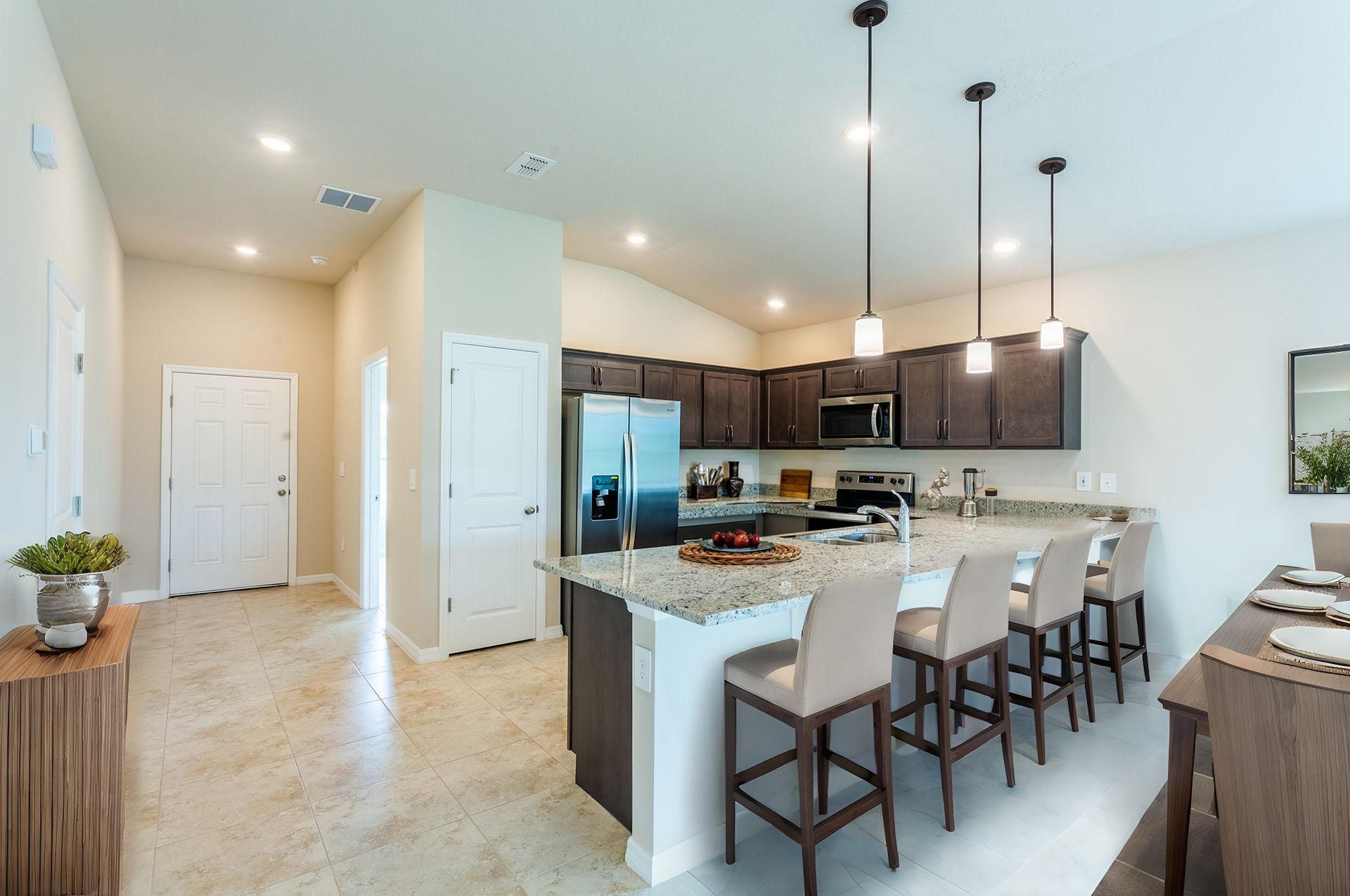 A kitchen with granite counter tops and stainless steel appliances