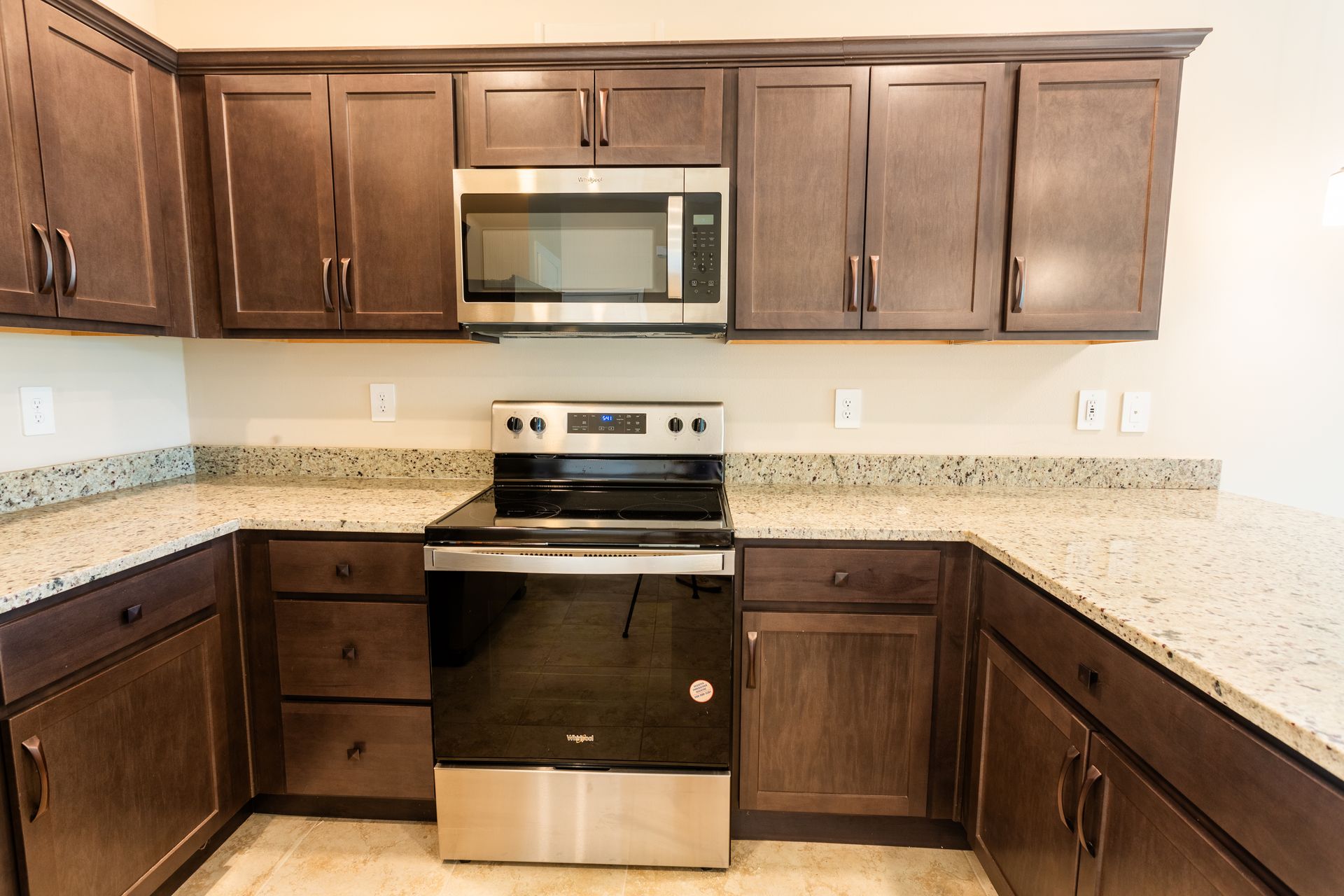 A kitchen with stainless steel appliances and granite counter tops