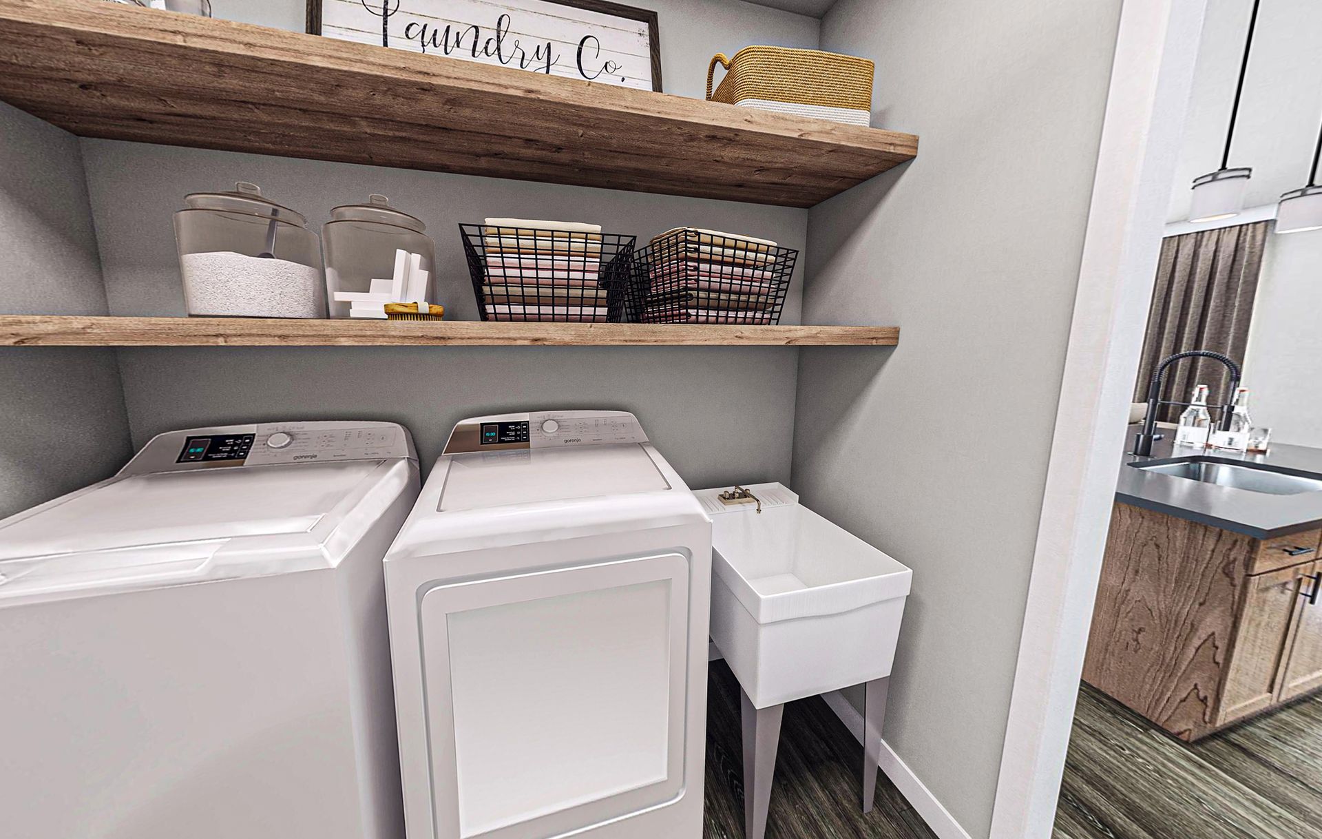 A laundry room with a washer and dryer and a sink.