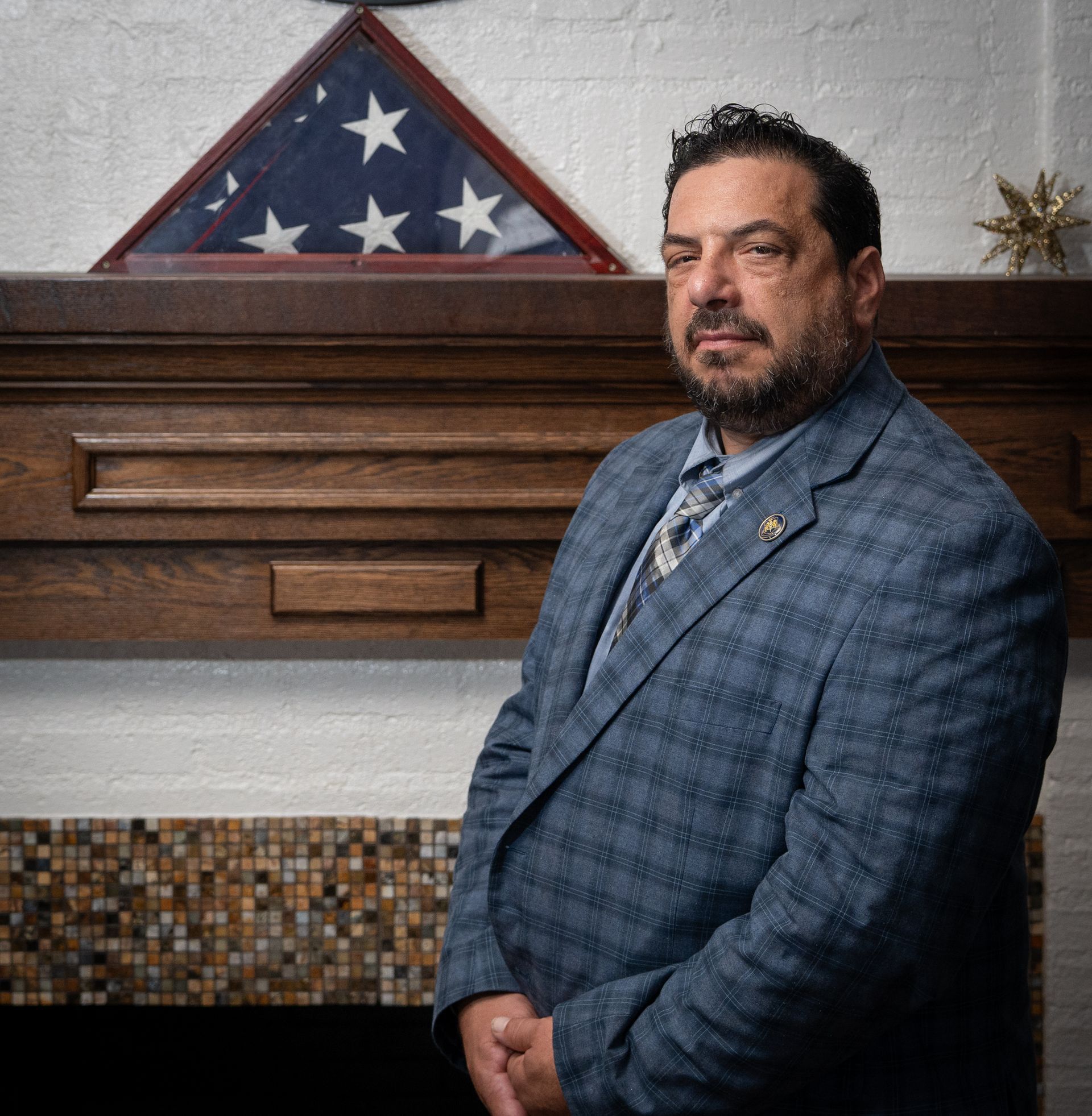 A man in a white shirt and blue tie is smiling for the camera.
