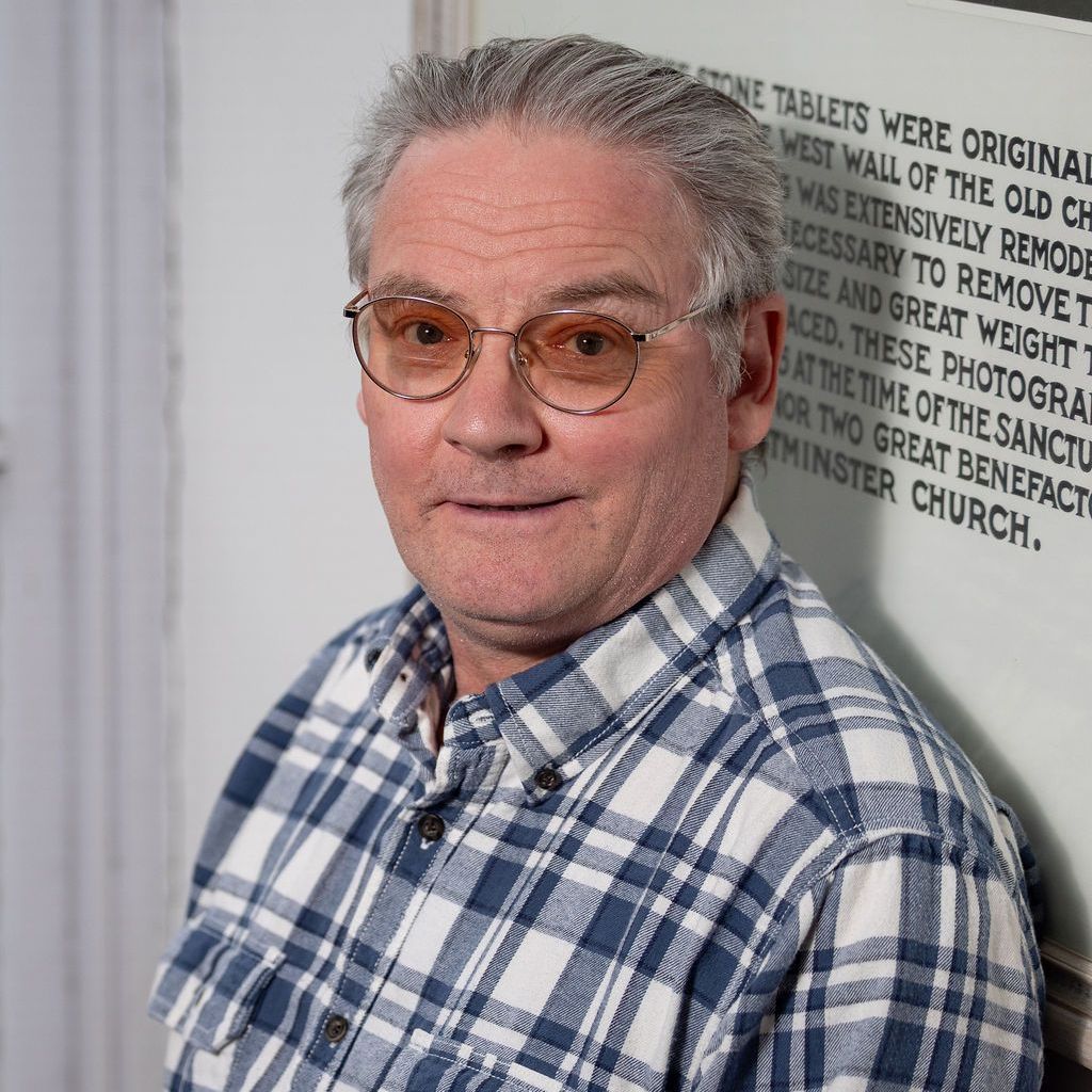 A woman without a face is wearing a suit and white shirt