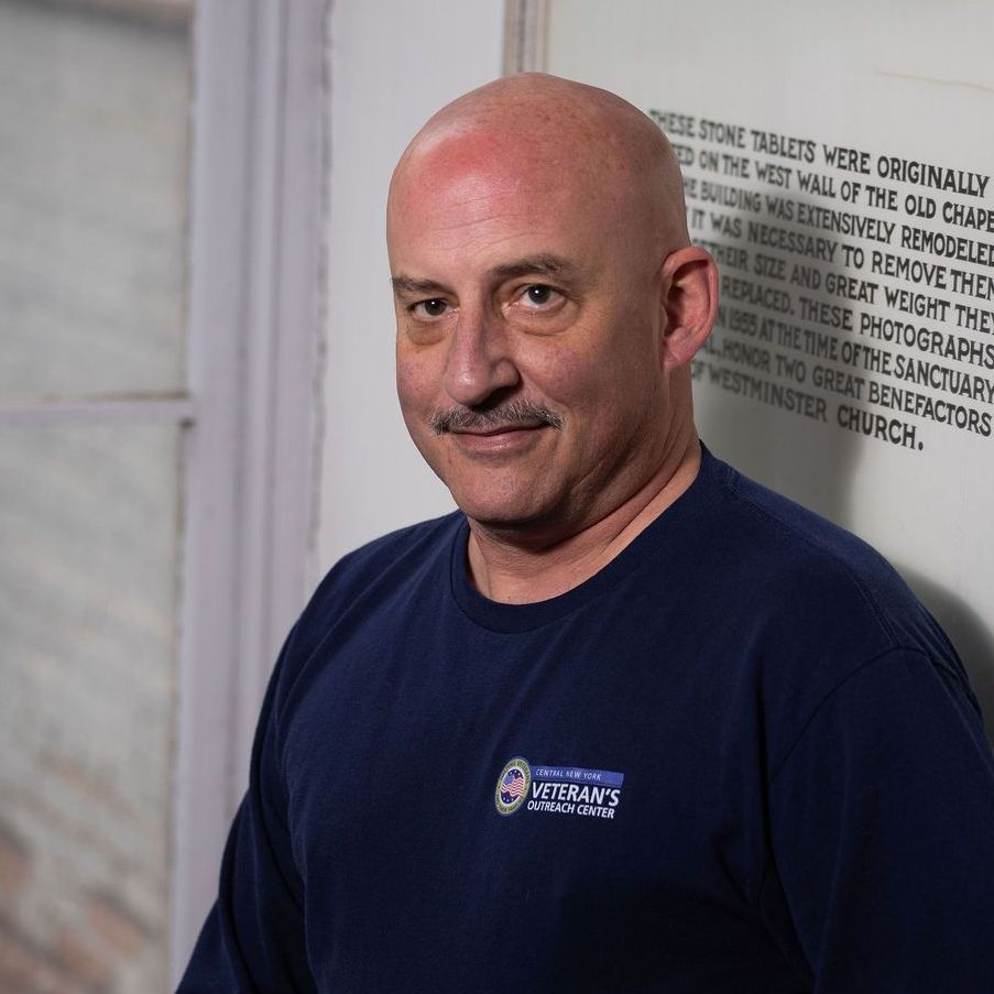 A woman without a face is wearing a suit and white shirt