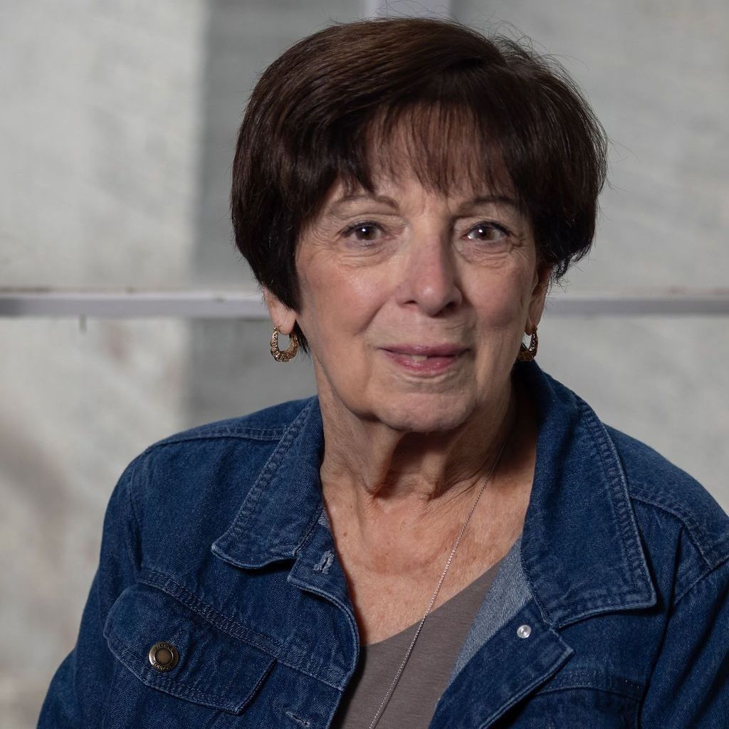 A woman without a face is wearing a suit and white shirt