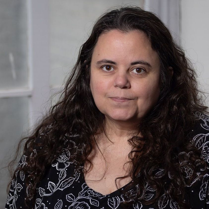 A woman without a face is wearing a suit and white shirt