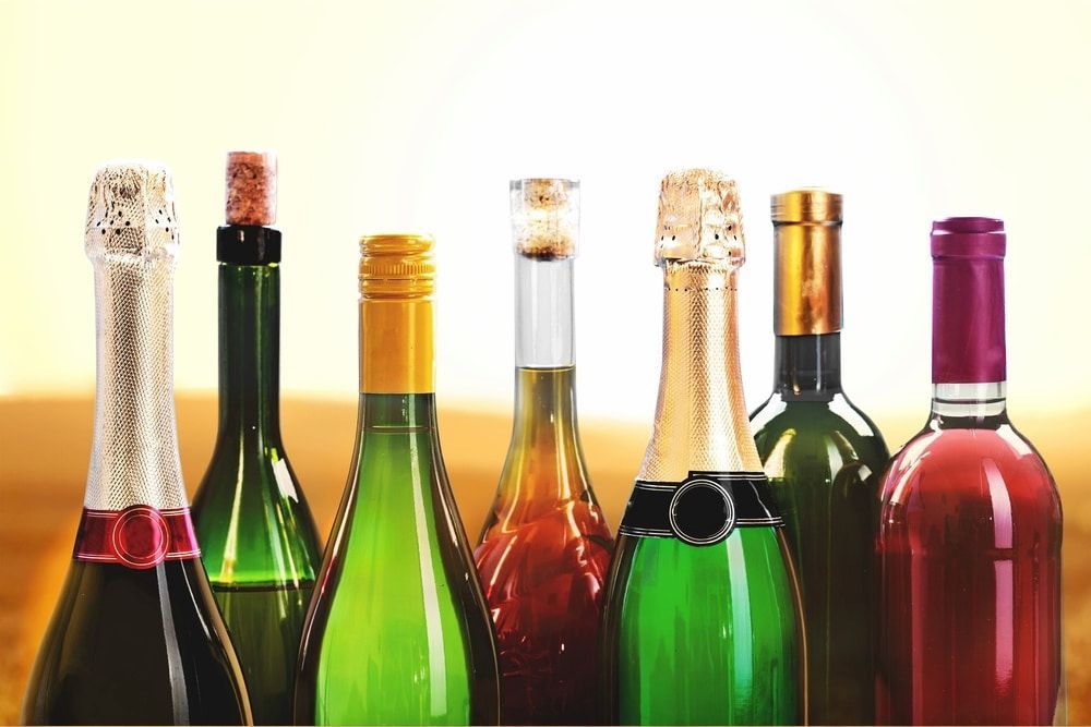 A Group of Wine Bottles Are Lined Up in a Row on a Table — Meraki Equestrian Centre in Mareeba, QLD