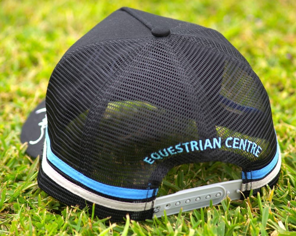 A Black Trucker Hat Says Equestrian Centre on the Back — Meraki Equestrian Centre in Mareeba, QLD