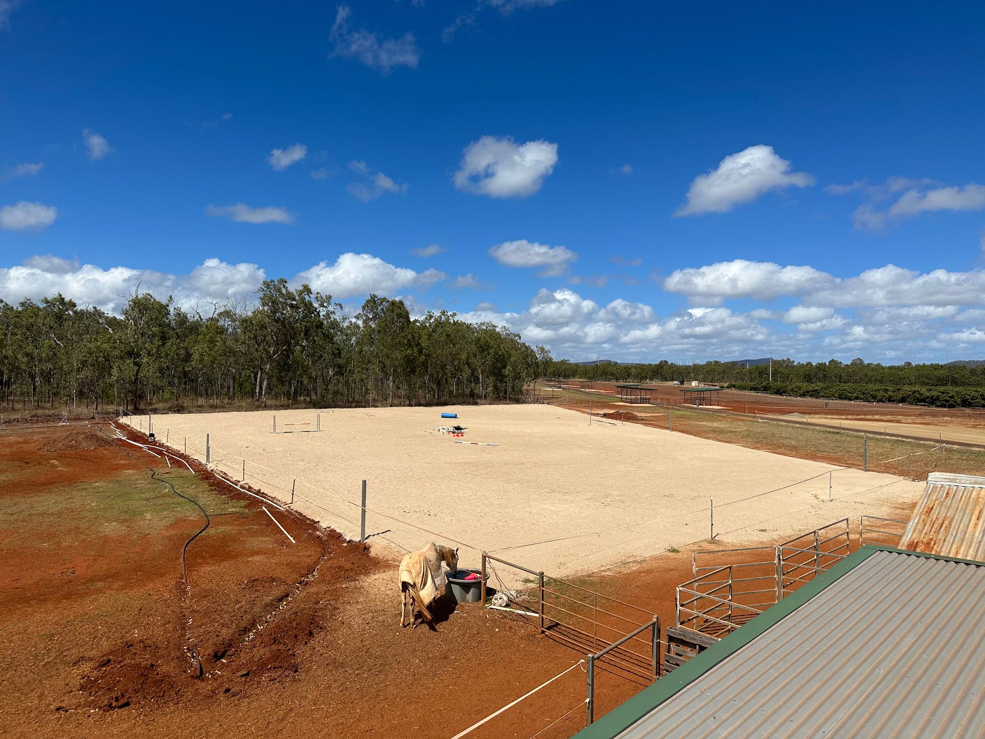 A Bulldozer is Moving Dirt in a Large Warehouse — Meraki Equestrian Centre in Mareeba, QLD