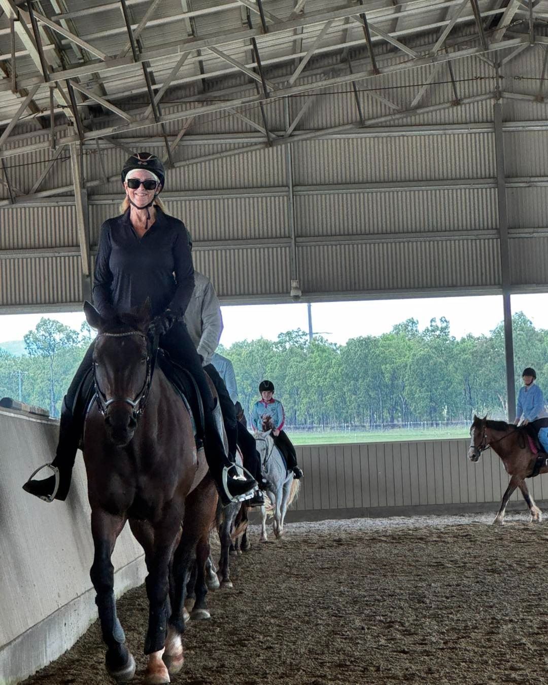 Person in Black Outfit Horse Riding