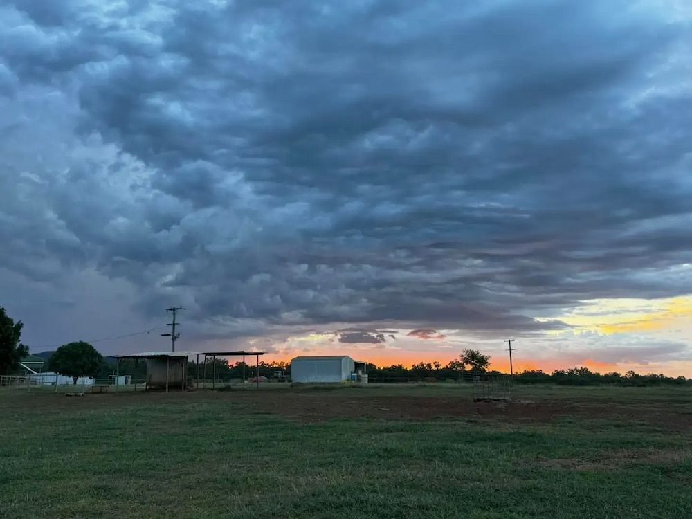 A Field With a Sunset in the Background and Clouds in the Sky — Meraki Equestrian Centre in Mareeba, QLD