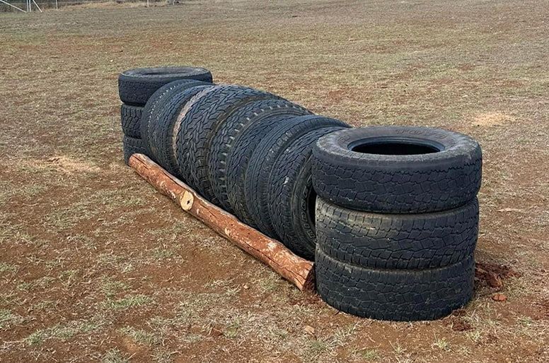 A Pile of Tires Sitting on Top of a Dirt Field — Meraki Equestrian Centre in Mareeba, QLD