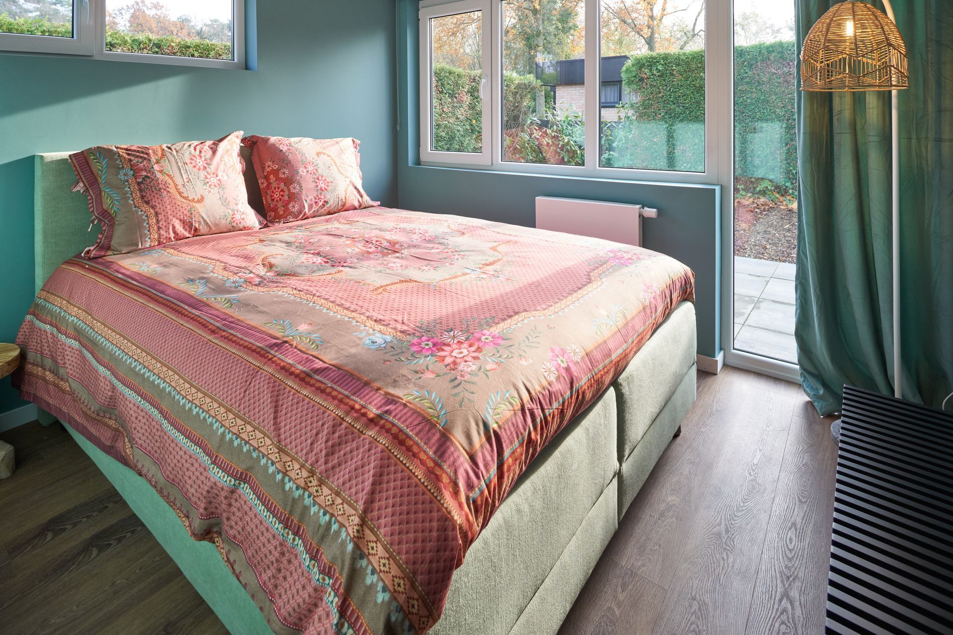 a bed with a pink comforter and pillows in a bedroom - Lacuna Vita holiday home