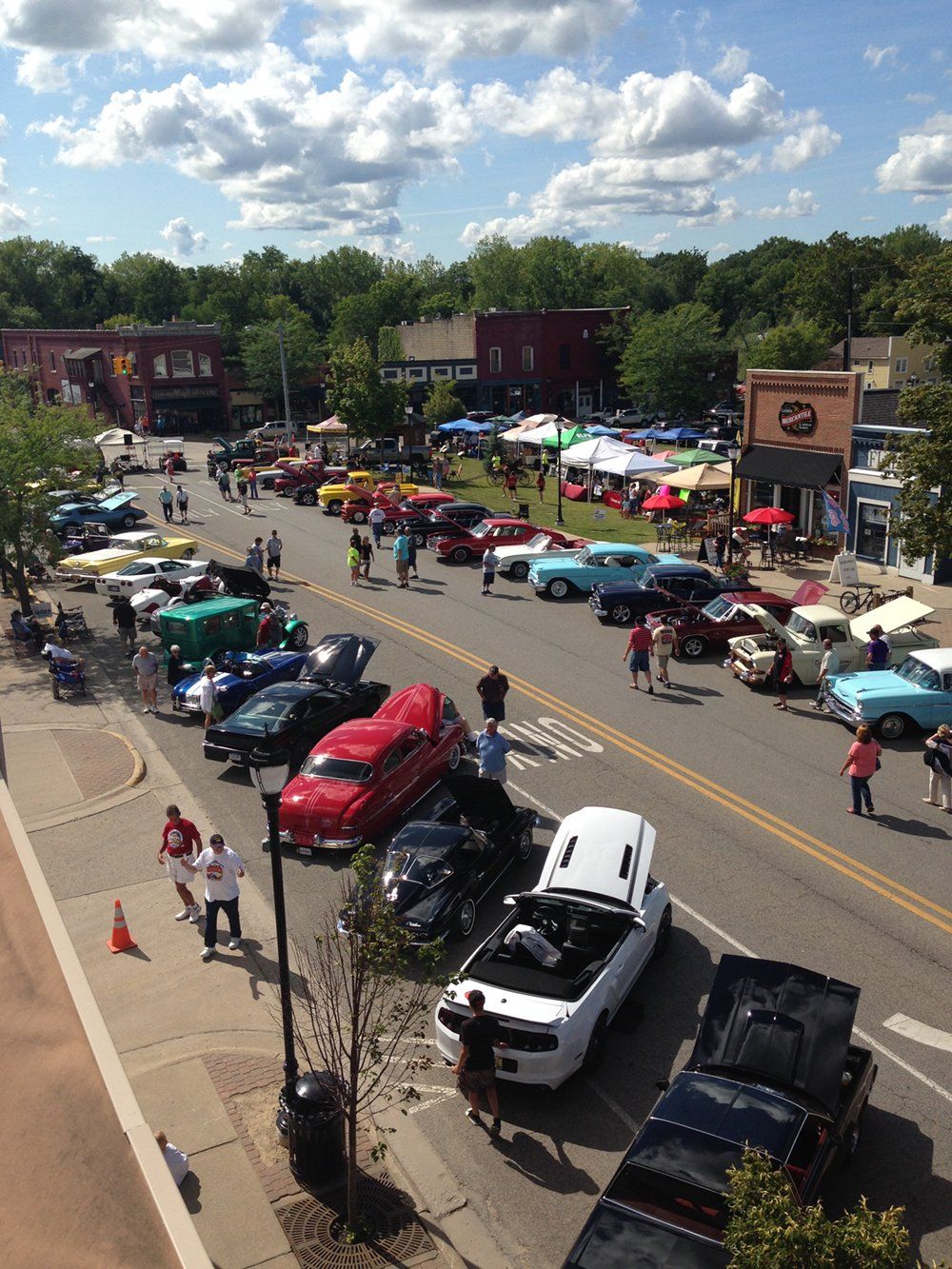 An aerial view of a car show in a small town
