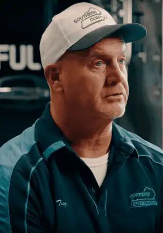 A gray square containing a white, abstract, stylized silhouette of a person’s head and shoulders.