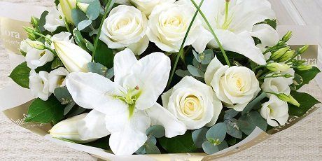 A white mixed-flower sympathy bouquet
