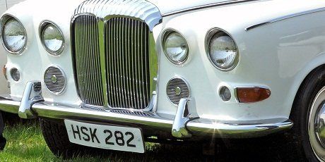 Close up of the grill and number plate of a white Daimler wedding car