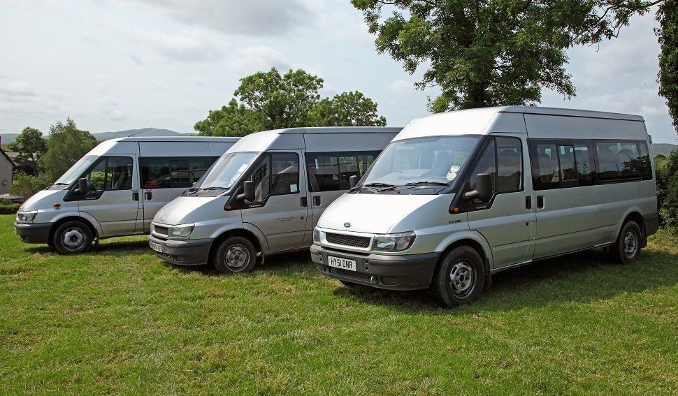 Three white minibuses