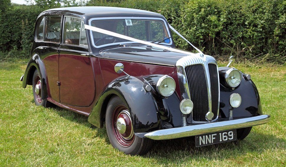 A brownish-red and black wedding car