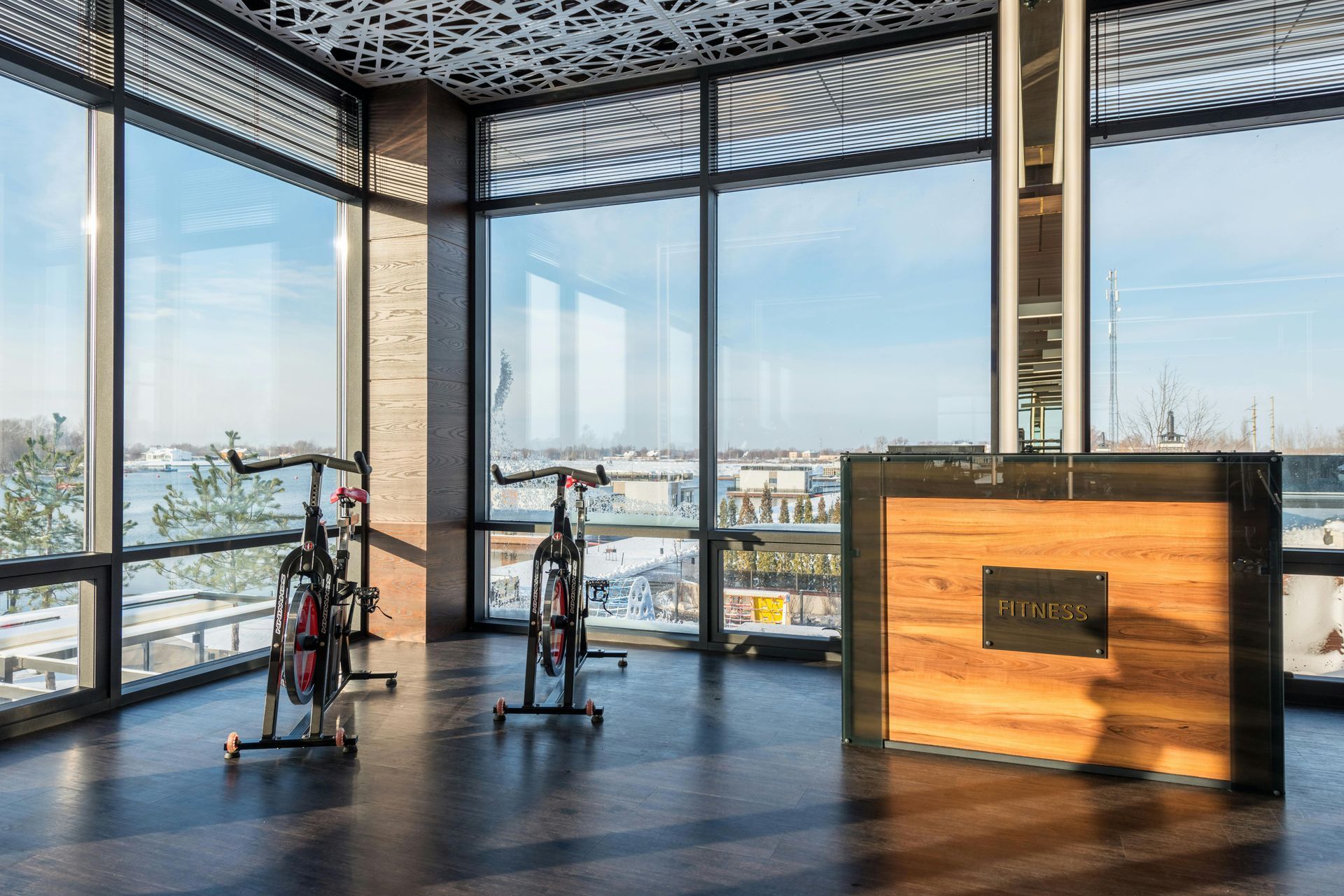 A large room with a lot of windows and exercise bikes