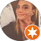 A woman is smiling in a circle with an orange star.