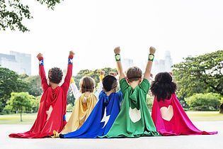 Gymnastics class: Young girls in leotards hug. Gym setting with equipment and instructor.