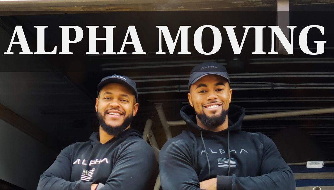 Two men are standing next to each other in front of a sign that says alpha moving.