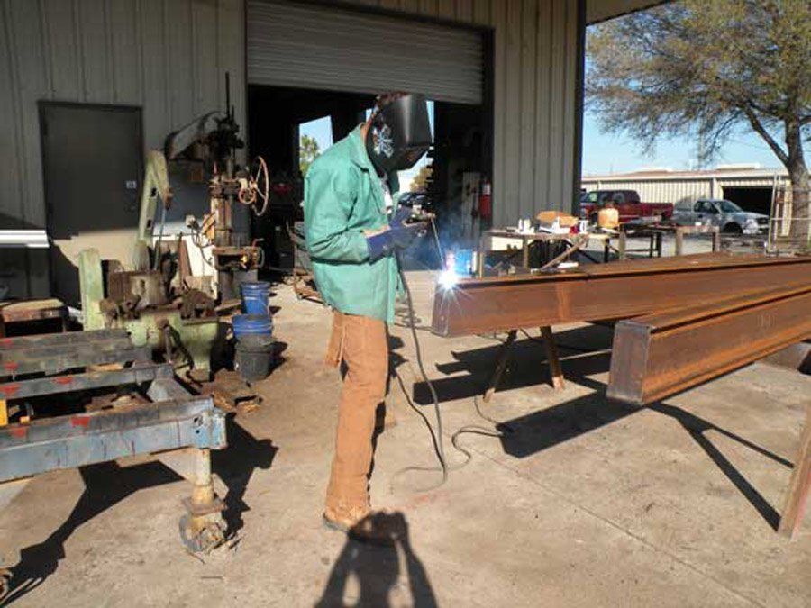 Man using a welding tool — Largo, FL — England Bros Construction