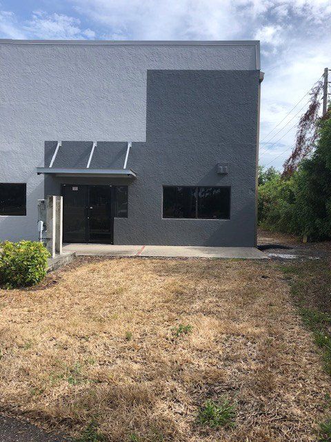Building with dry grass in front — Largo, FL — England Bros Construction