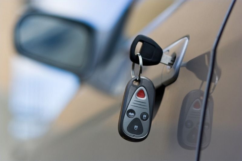 A close up of a car door with a key in it