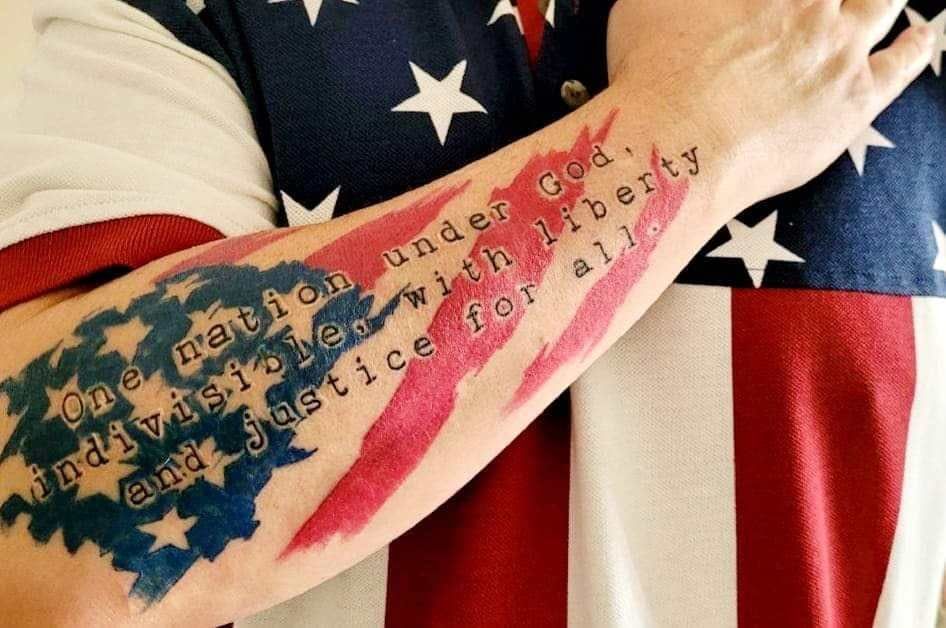 A person with an american flag tattoo on their arm