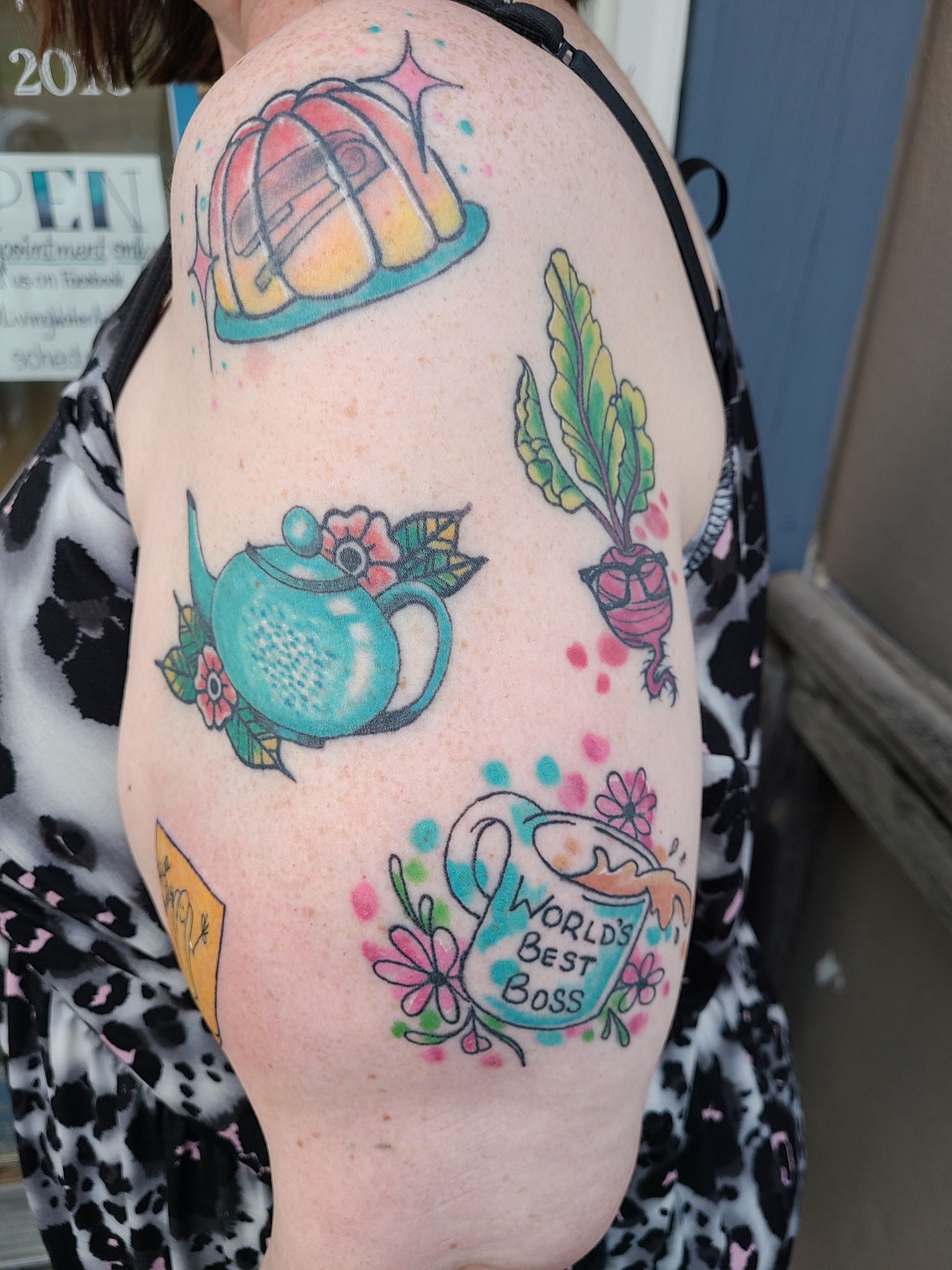 A woman has a tattoo on her arm that says world 's best boss