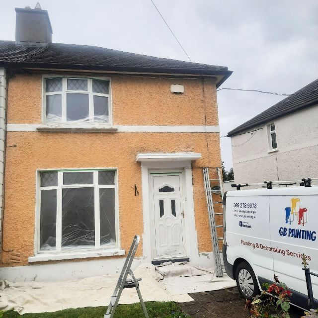 A white van that says go painting is parked in front of a house