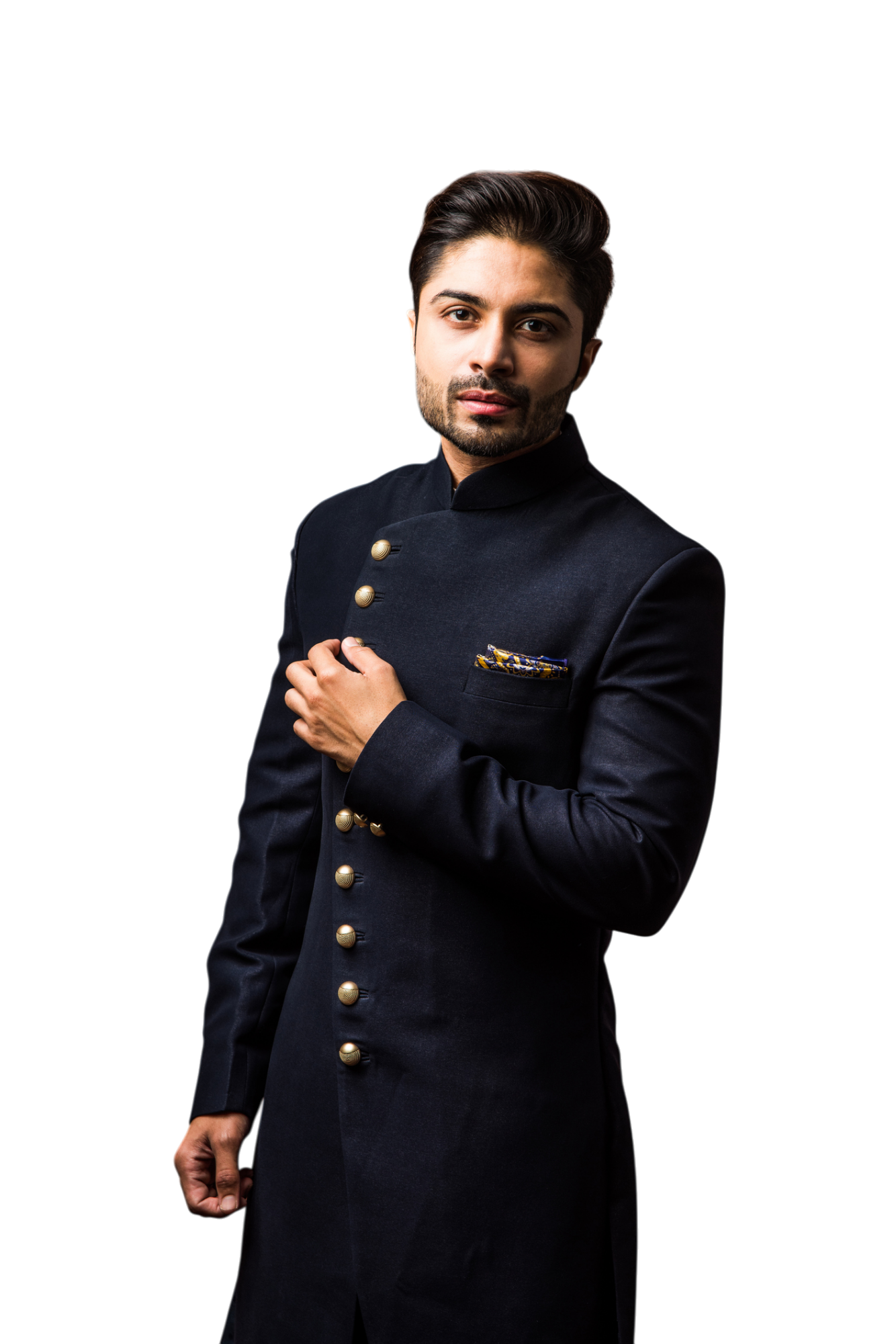A well-dressed man in a dark blue sherwani with gold buttons, looking at the viewer.