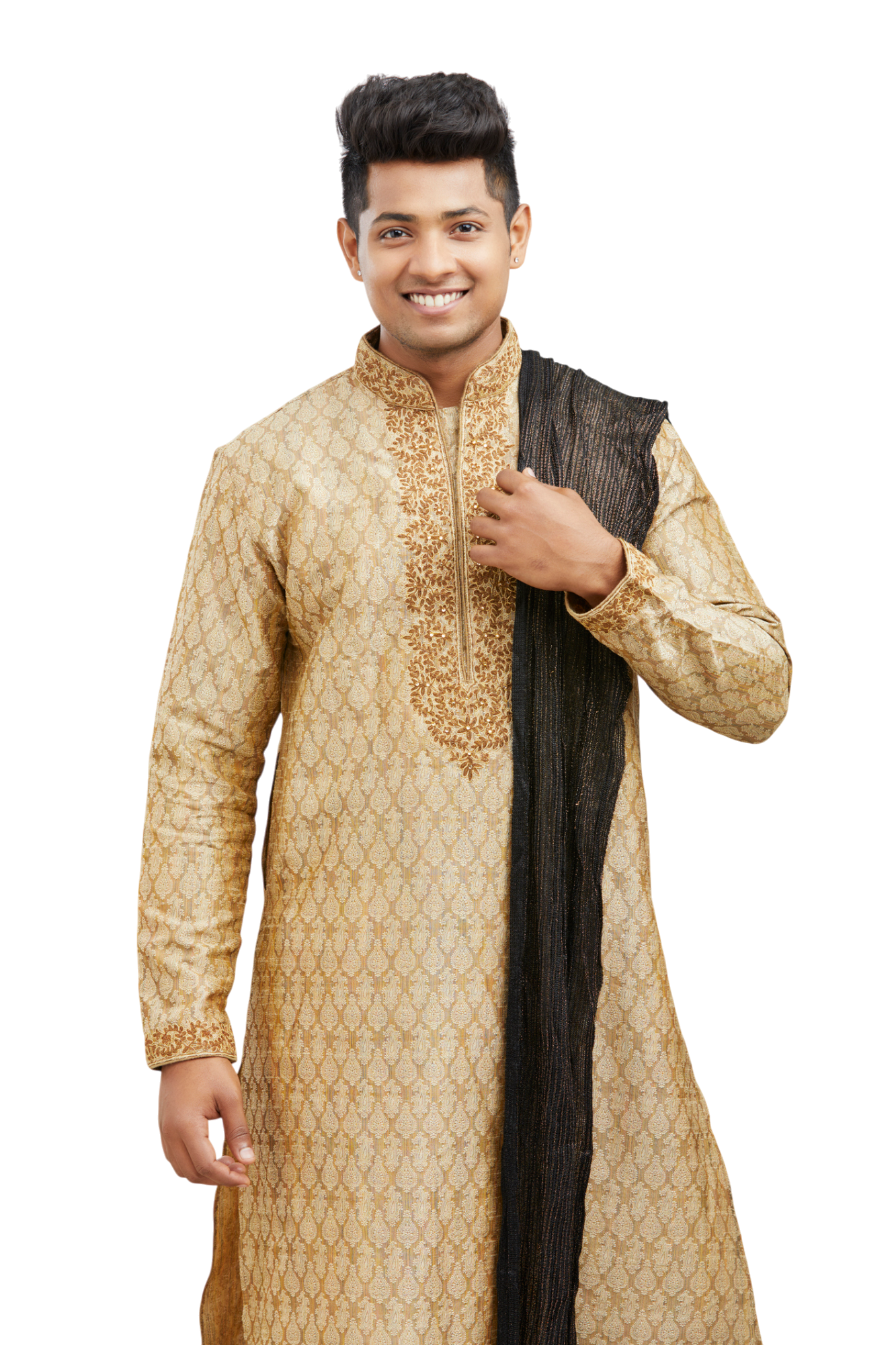 A smiling man wearing a gold kurta with intricate embroidery and a black shawl, standing against a white background.