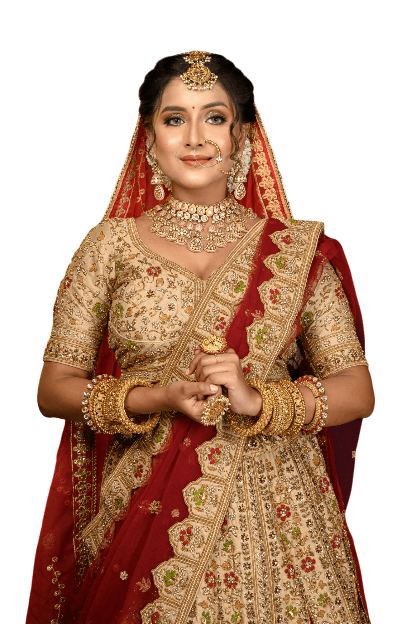 Bride in gold and red traditional Indian wedding attire, smiling, adorned with jewelry.