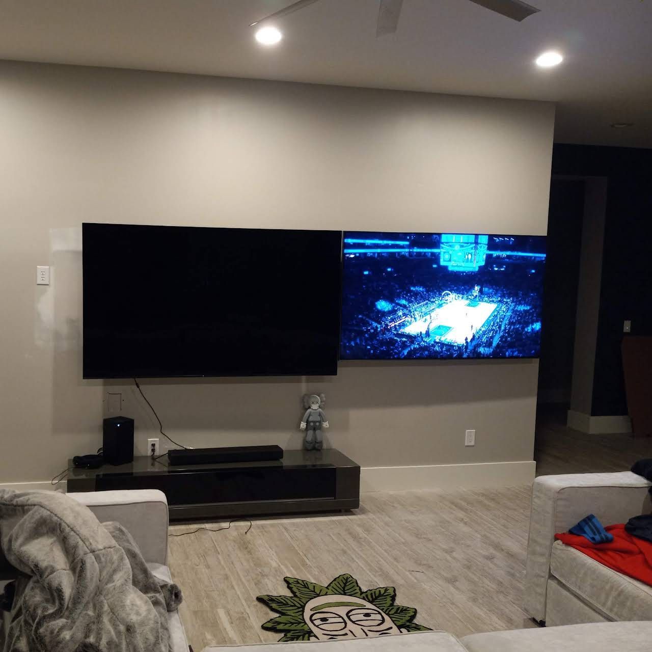A living room with a large flat screen tv on the wall