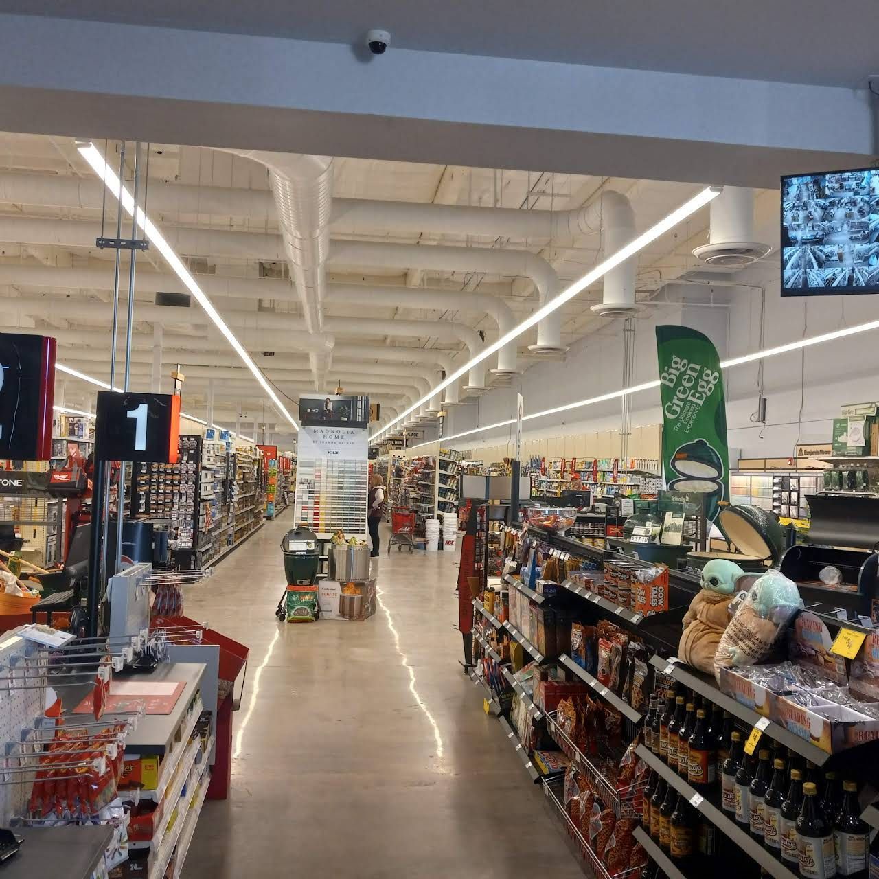 An aisle of a grocery store with a sign that says 1