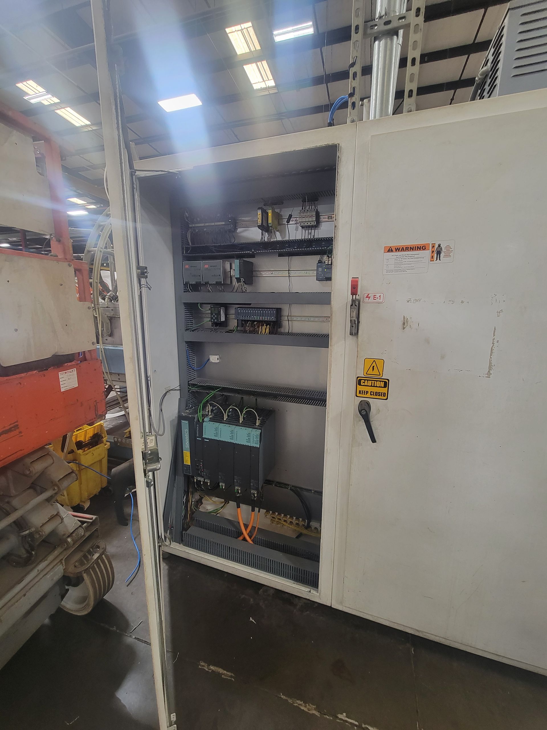 A large electrical box is sitting in a warehouse.