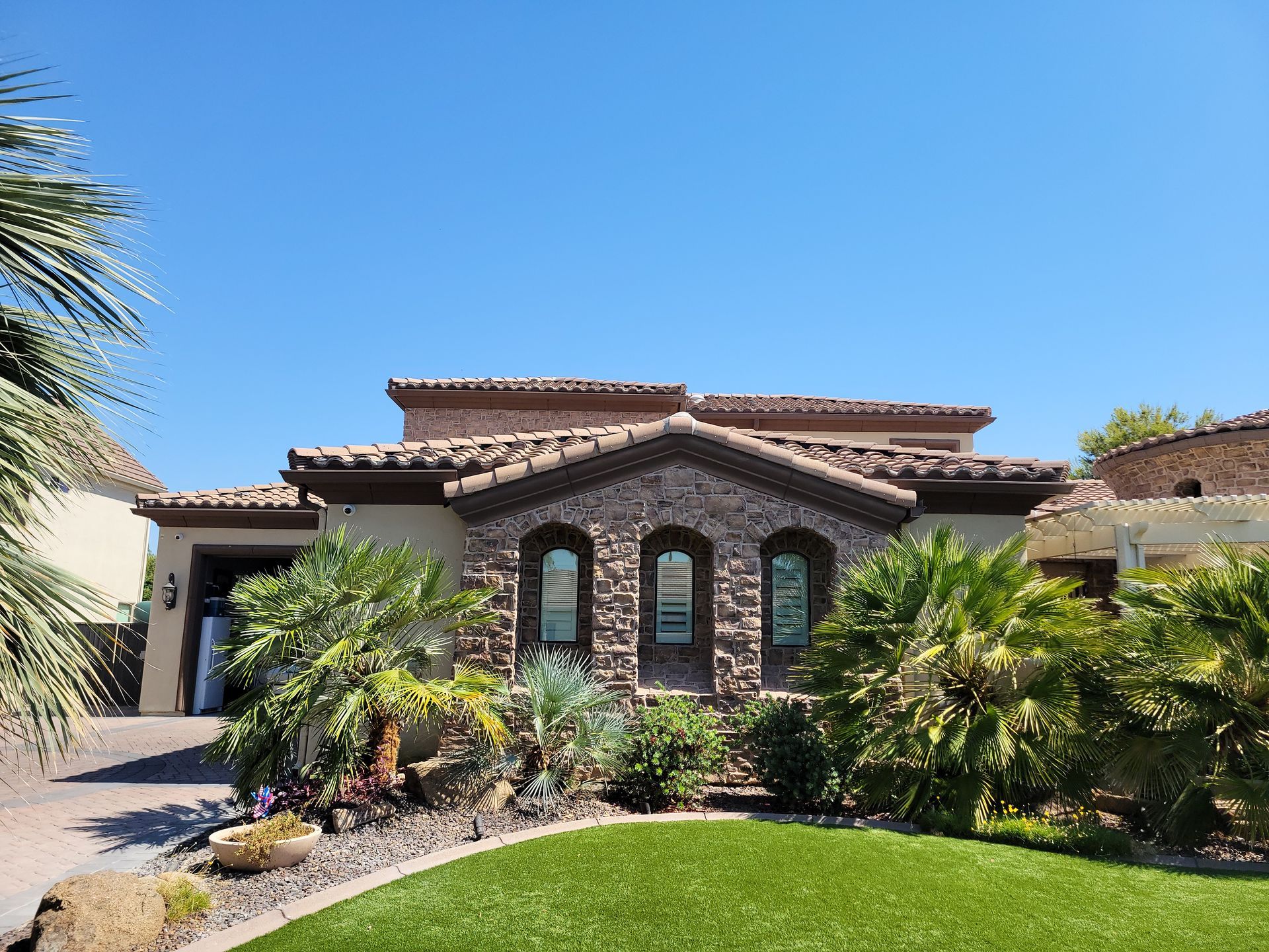 A large house with a lush green lawn in front of it
