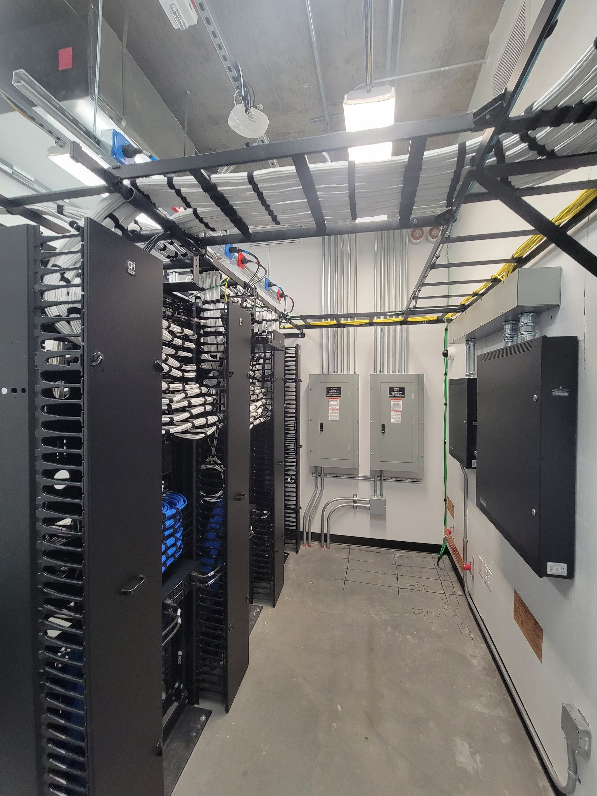 A server room filled with lots of racks and servers.