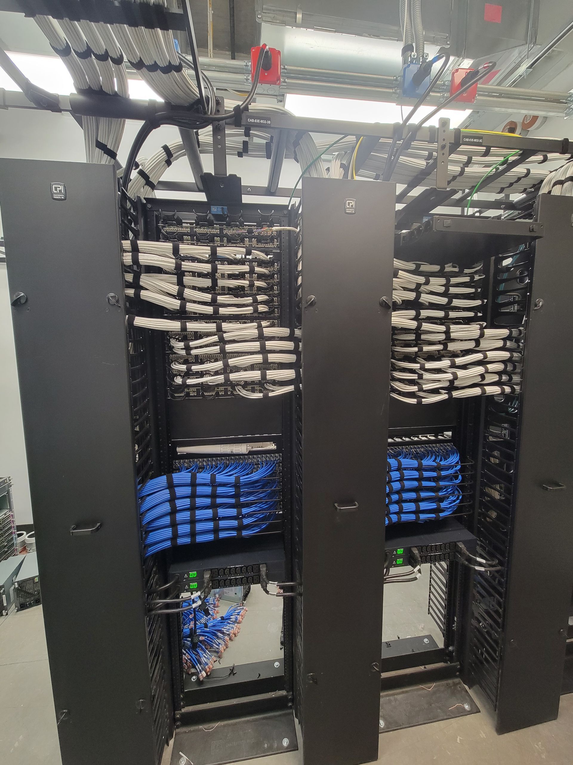 A server rack filled with lots of wires and cables.