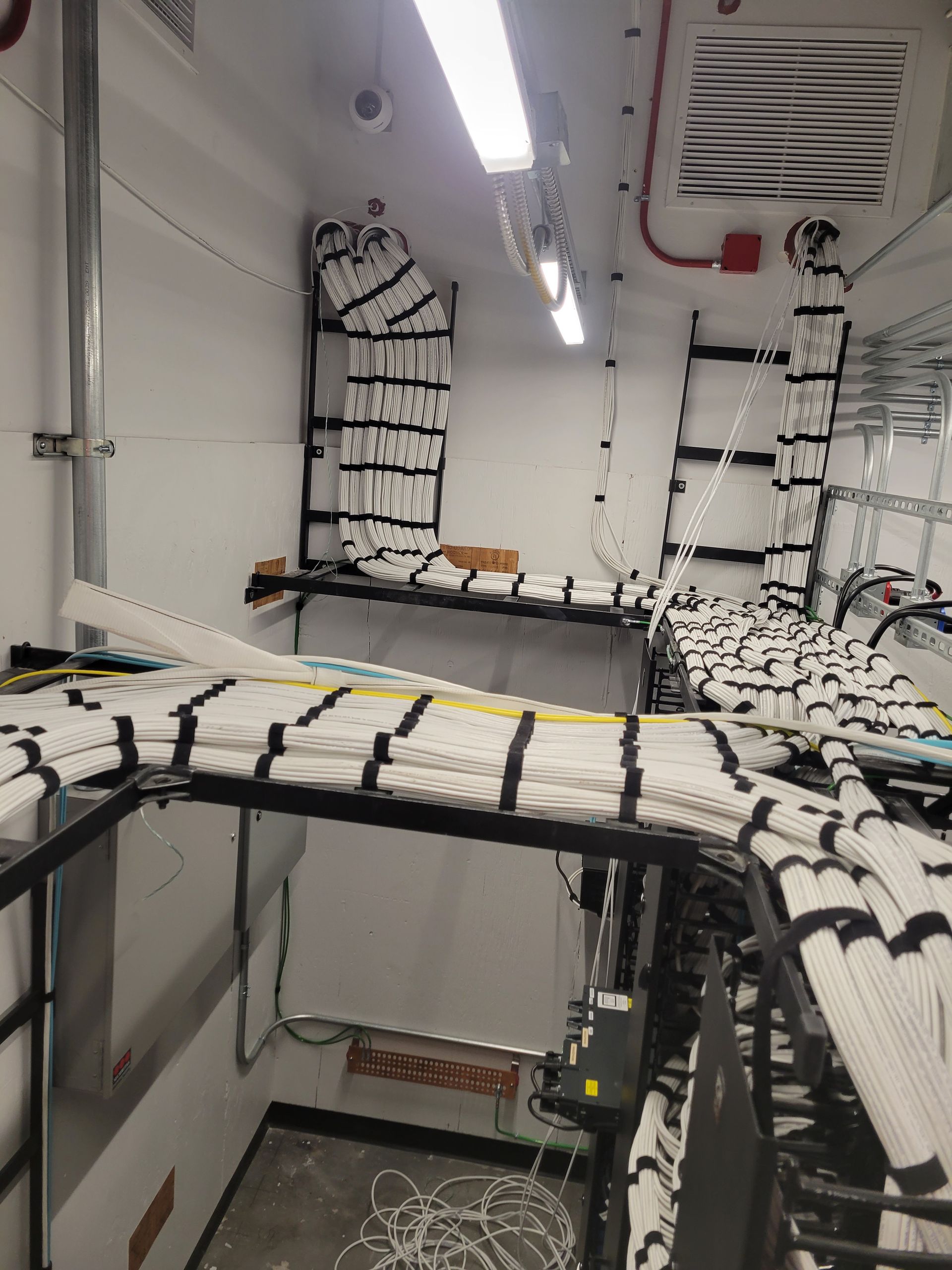 A room with a lot of wires hanging from the ceiling.