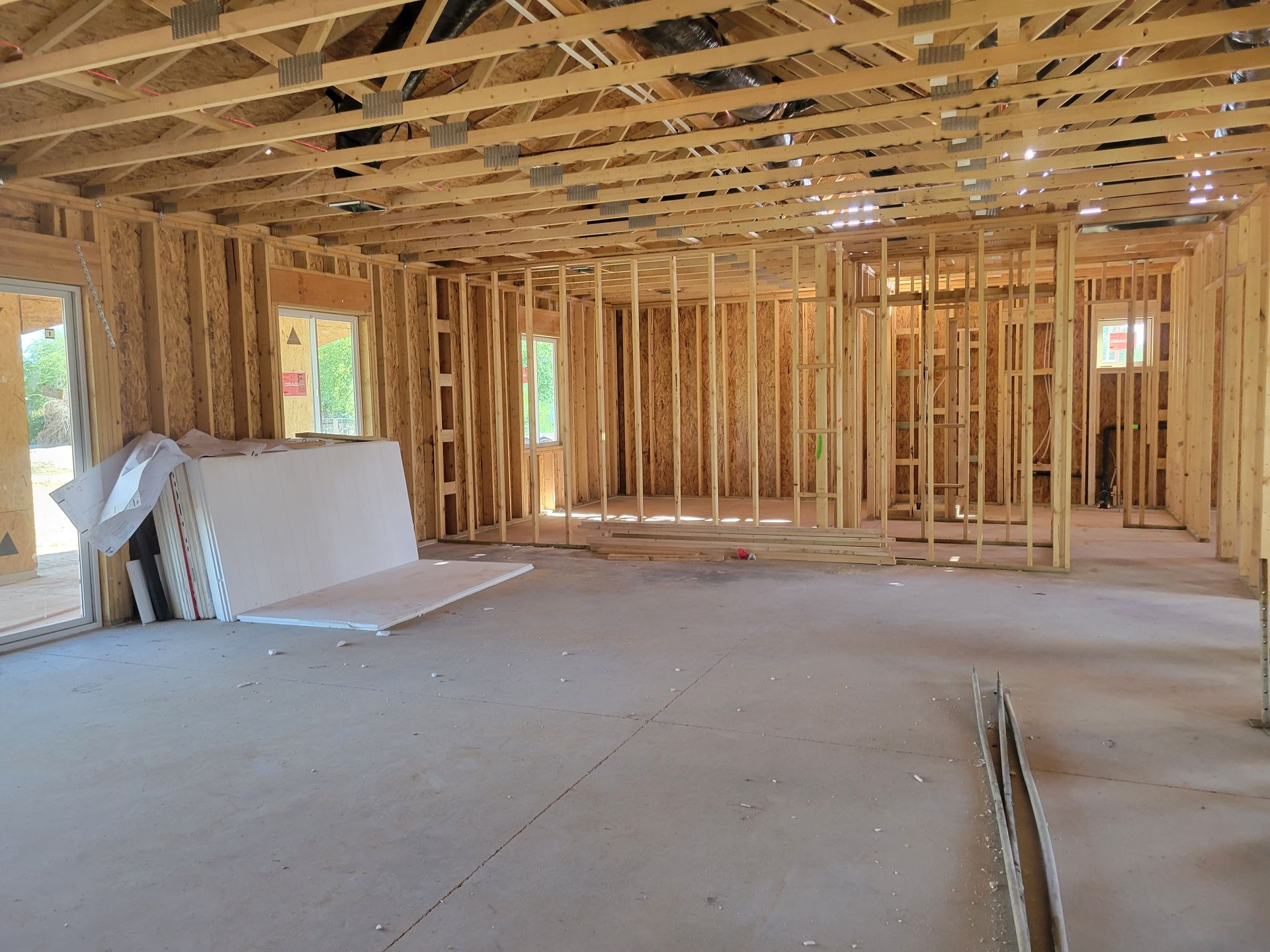 An empty room in a house under construction with wooden beams.