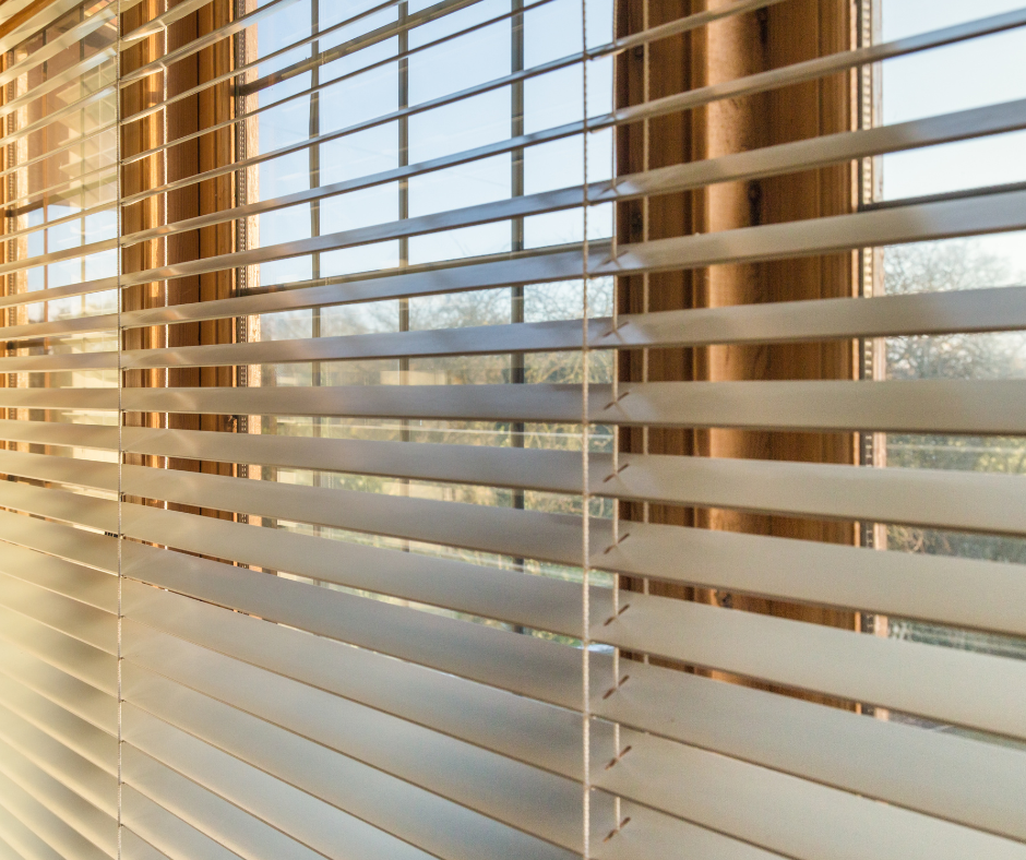 A close up of a window with blinds on it.