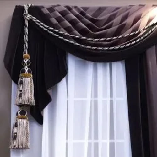 A close up of a window with curtains and tassels