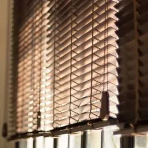 A close up of a window with blinds on it.