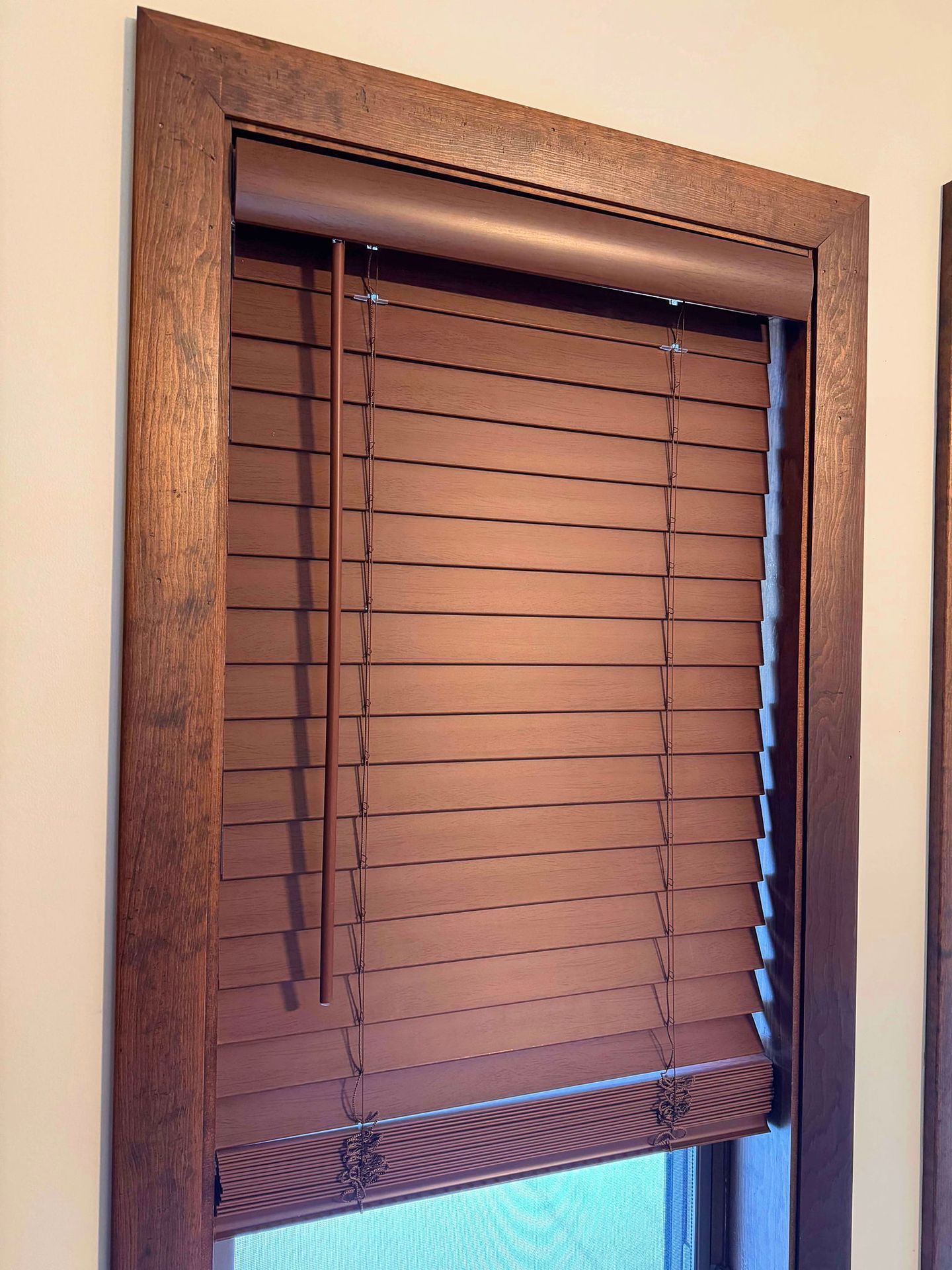 A close up of a wooden blind on a window