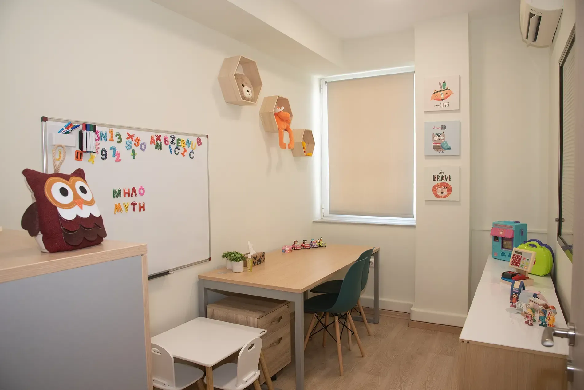 Ένα δωμάτιο με τραπέζι, καρέκλες και έναν πίνακα.