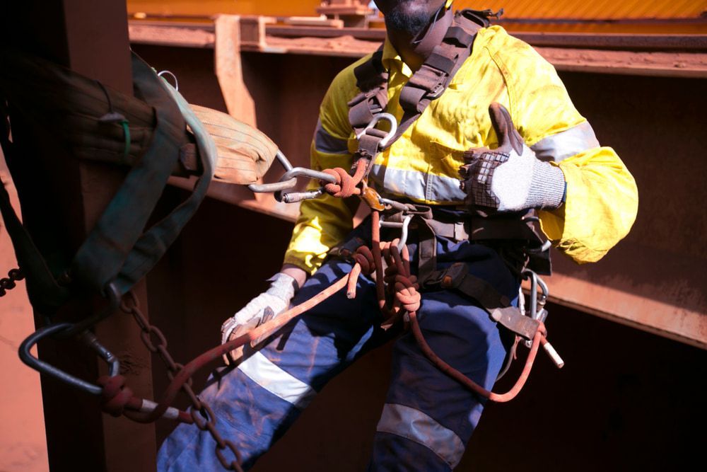 Worker Safely Hanging On, Secured by Safety Harness and Clip for AAS Height Safety & Lifting Solutions — Height Safety in Cairns, QLD